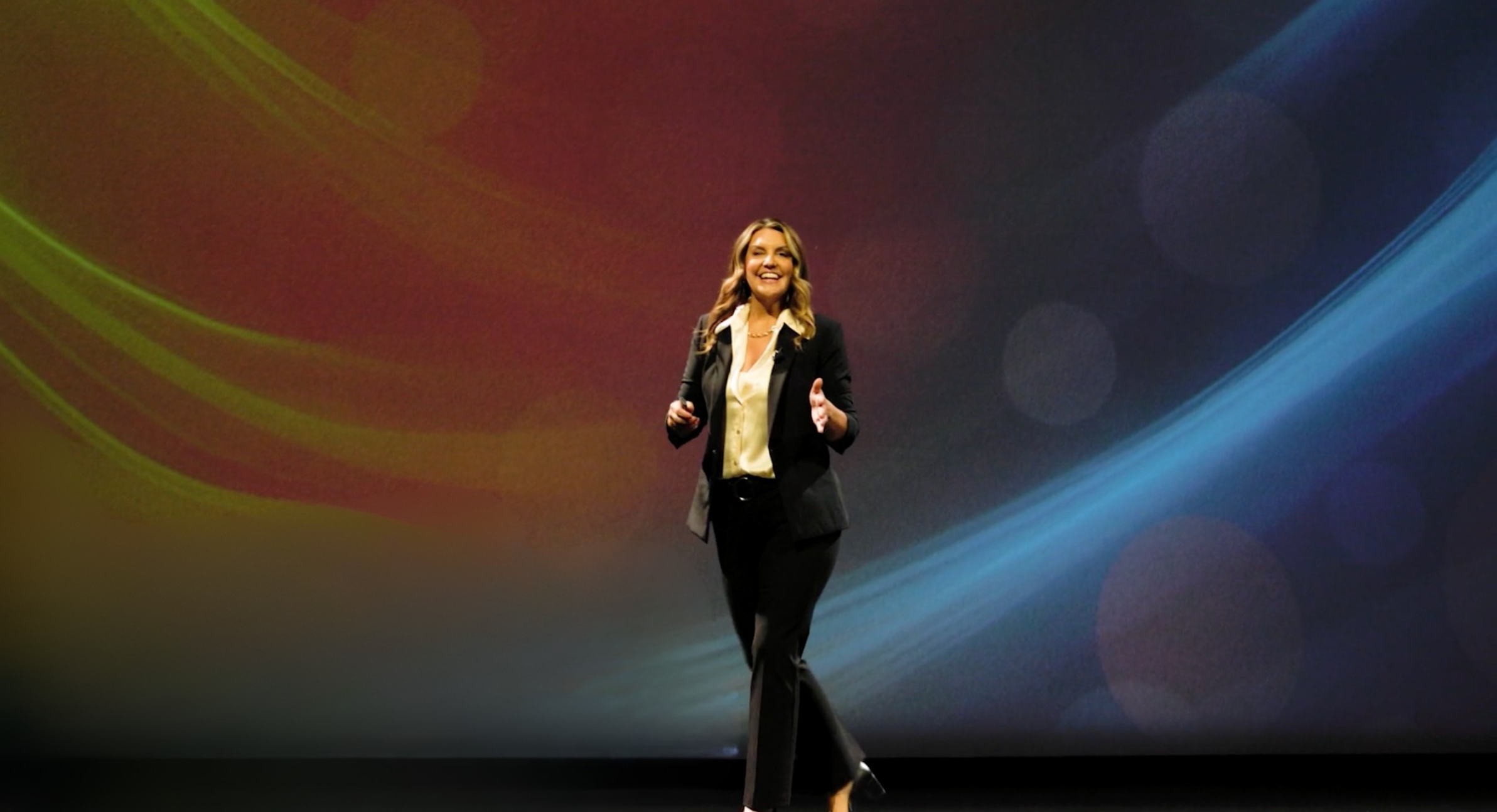 Tacy Riehm speaking on stage.