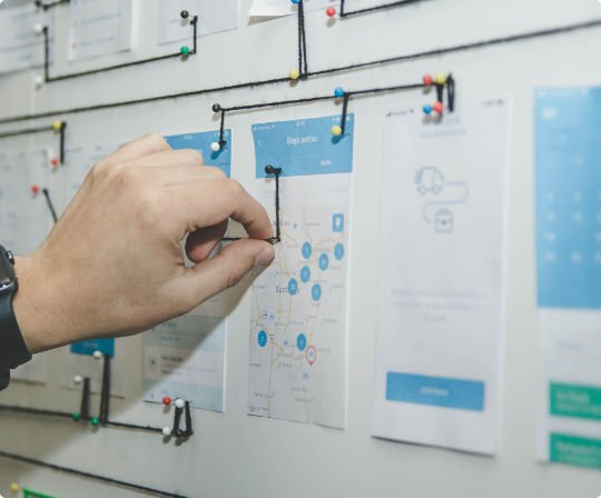 A person's hand doing a design brainstorming branding process