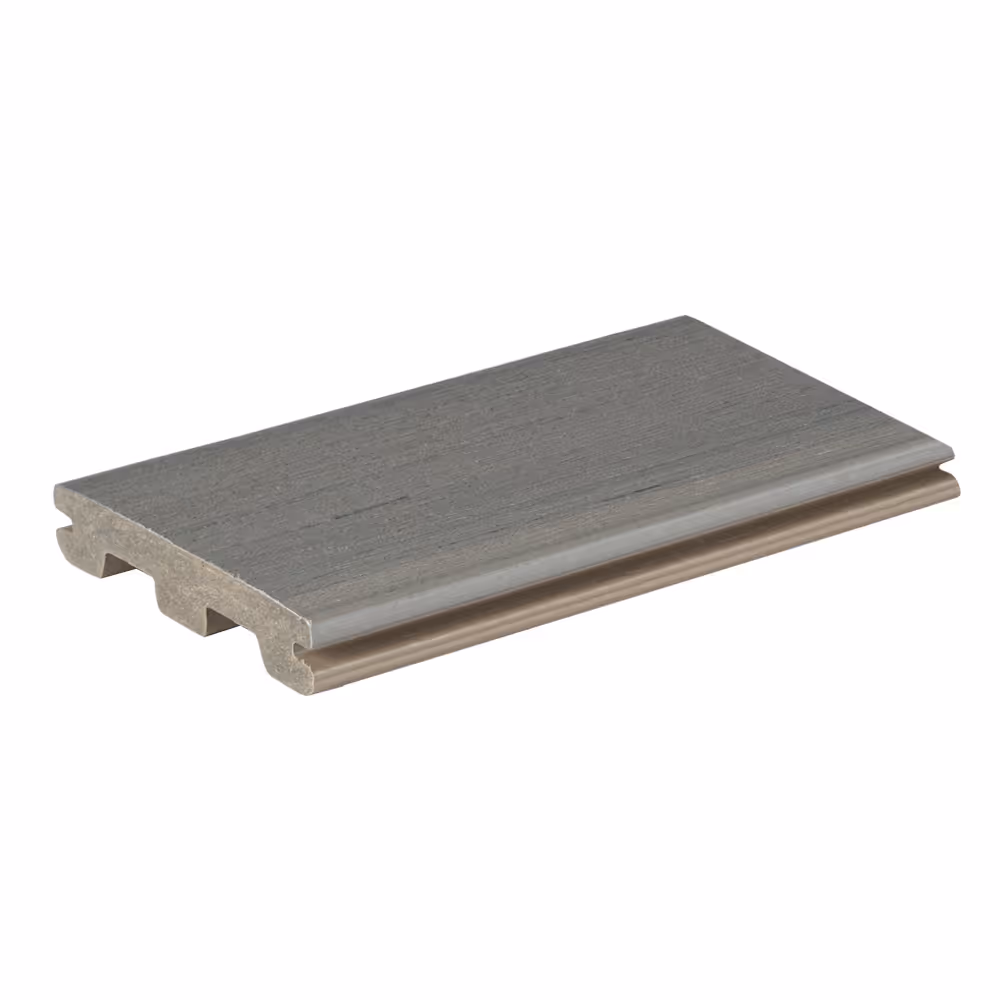 Gray composite decking board with grooved underside on white background.