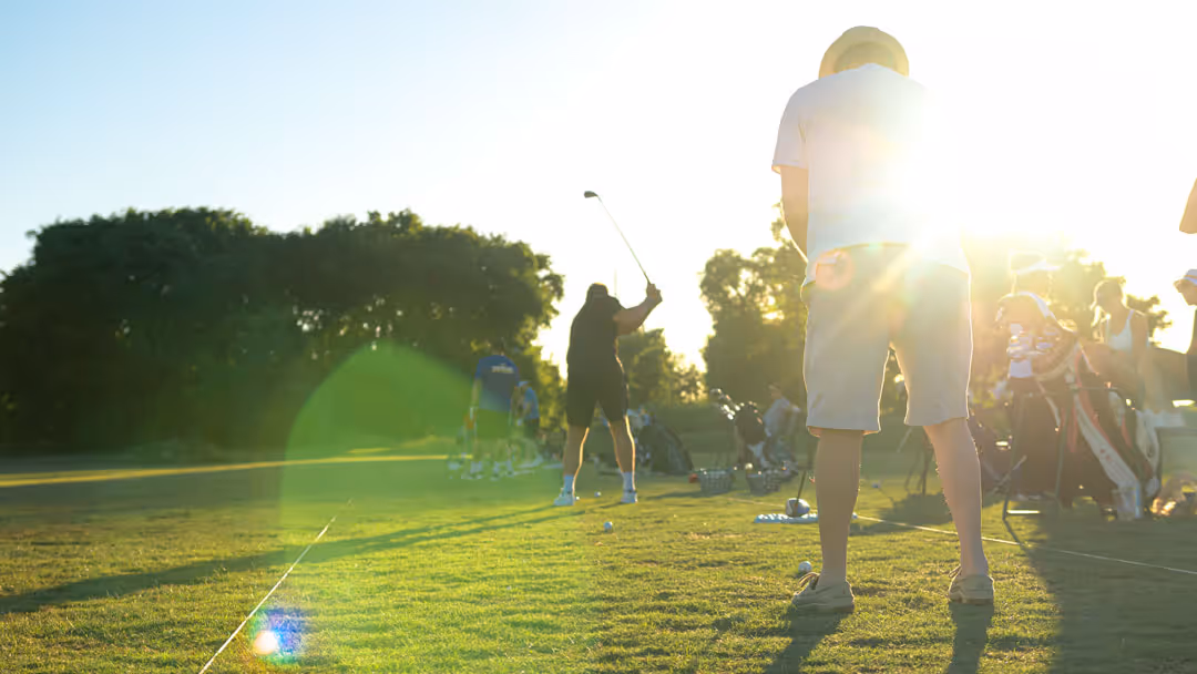 Men playing golf at noon time