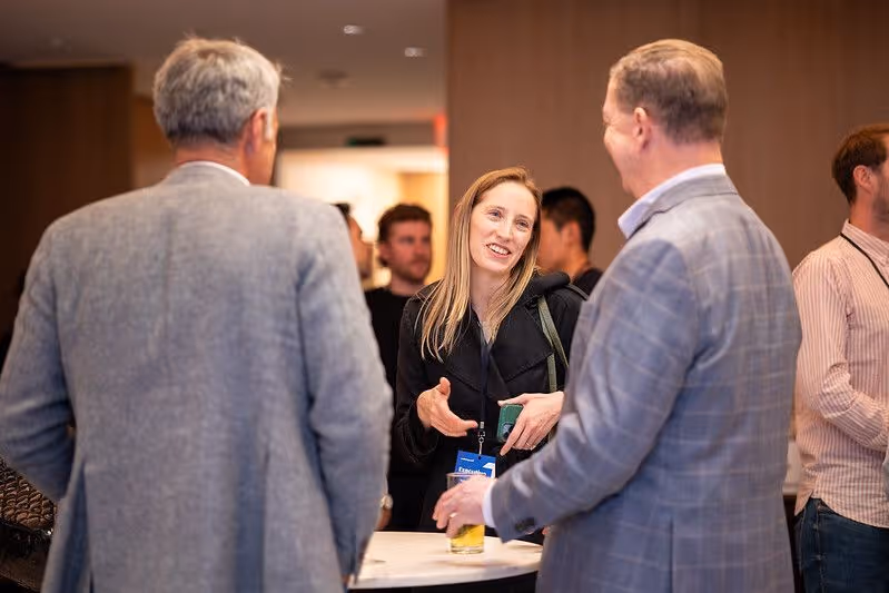 Entrepreneur speaking with investors during a networking session, building connections in the startup and venture capital community.