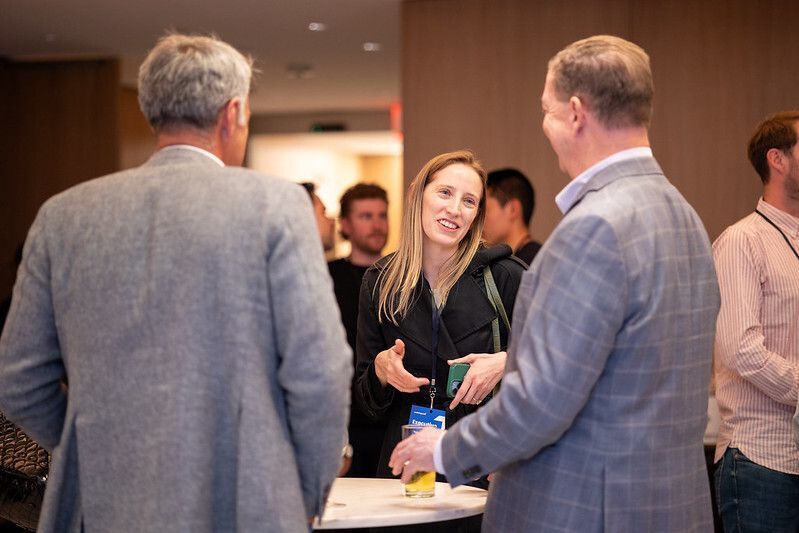 Entrepreneur speaking with investors during a networking session, building connections in the startup and venture capital community.