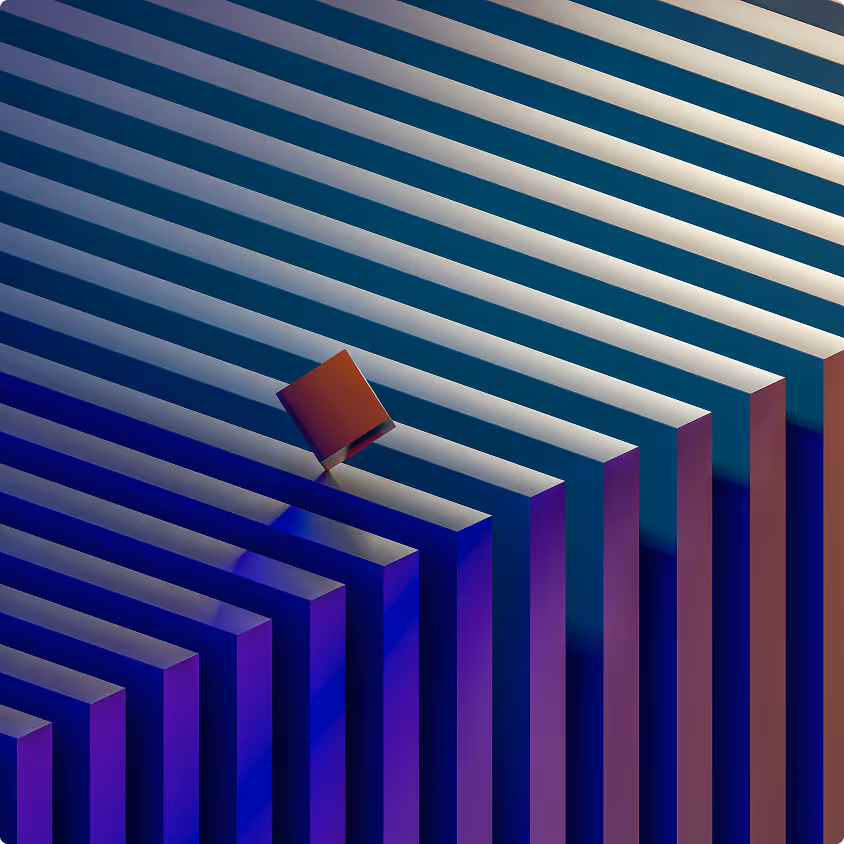 Red cube balancing on edge atop a series of blue and white rectangular bars arranged in a geometric pattern.