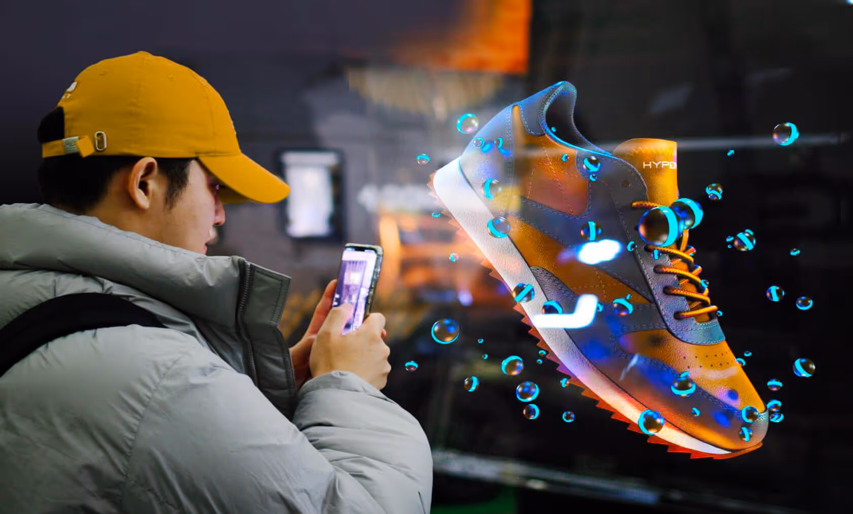 Person in yellow cap and gray jacket using a smartphone to view a holographic floating sneaker with blue glowing orbs around it.