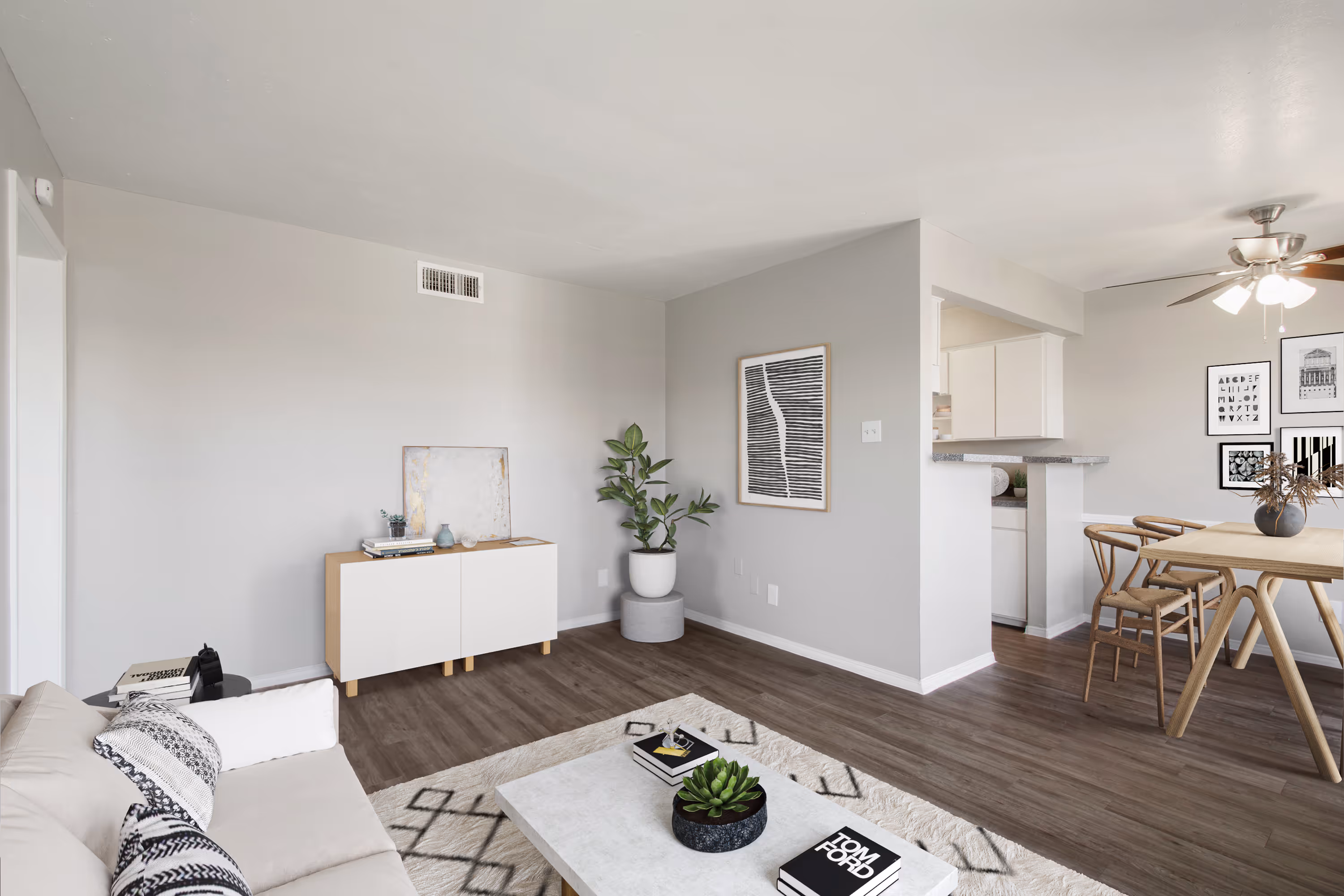 living area with rug, sofa, and painting on wall