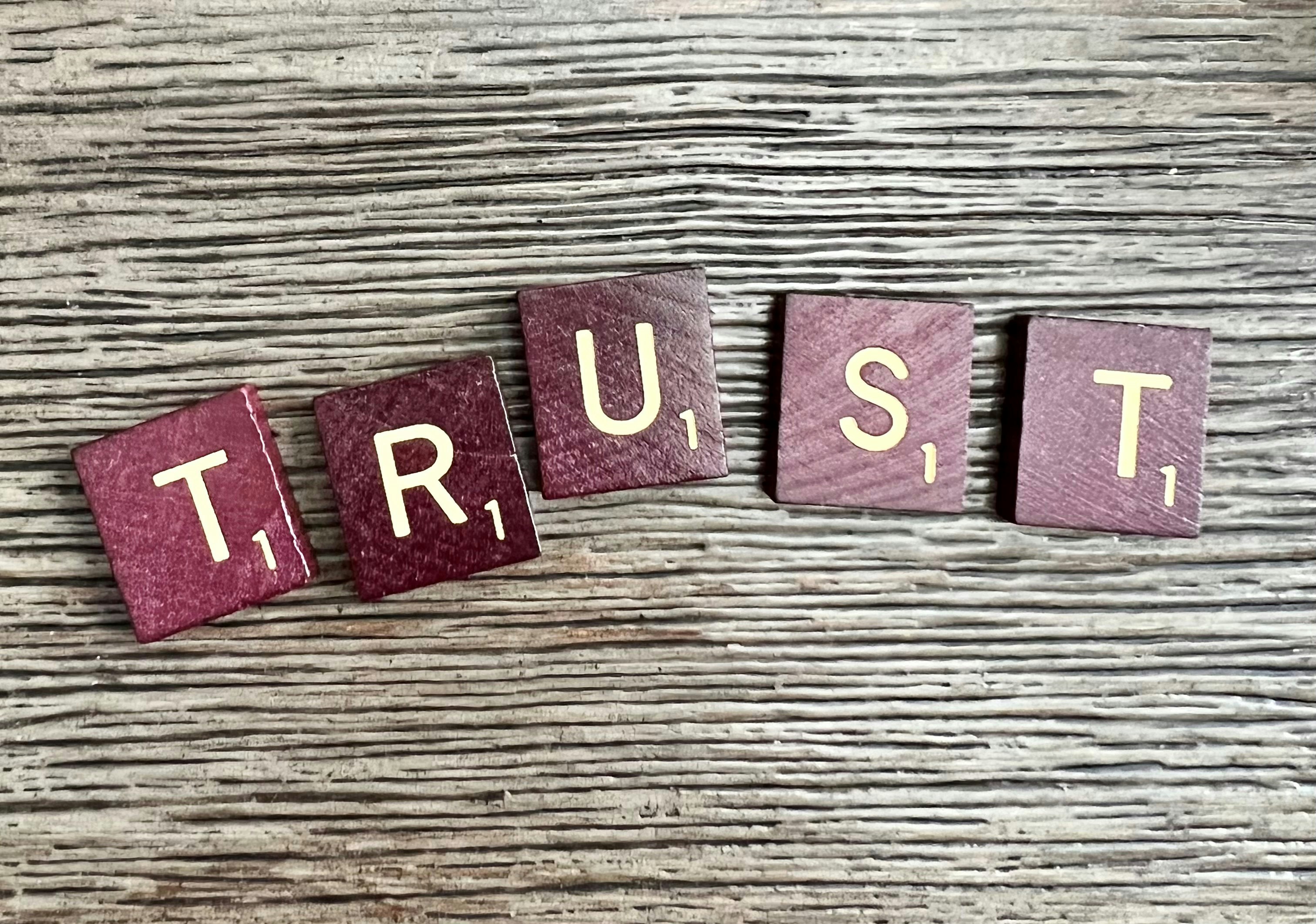 Letter tiles spelling out the word "trust"
