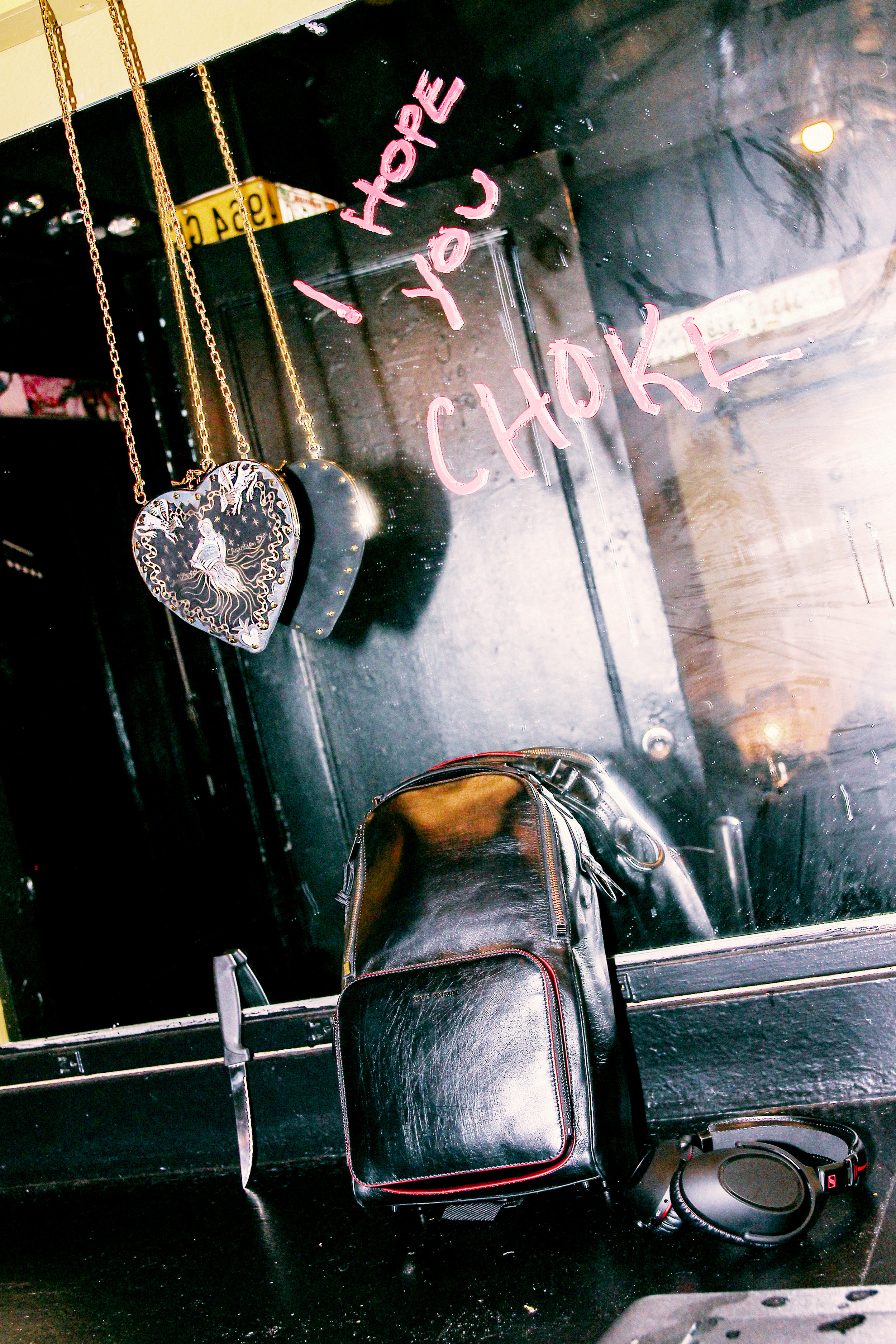 DIOR hand-painted velvet lambskin ‘Le Coeur de Dior’ bag and ‘Addict’ lacquer stick in diabolo. DIOR HOMME x SENNHEISER ‘The Travel Solution’ backpack and headphones. DIOR ‘Addict’ lacquer stick in diabolo.