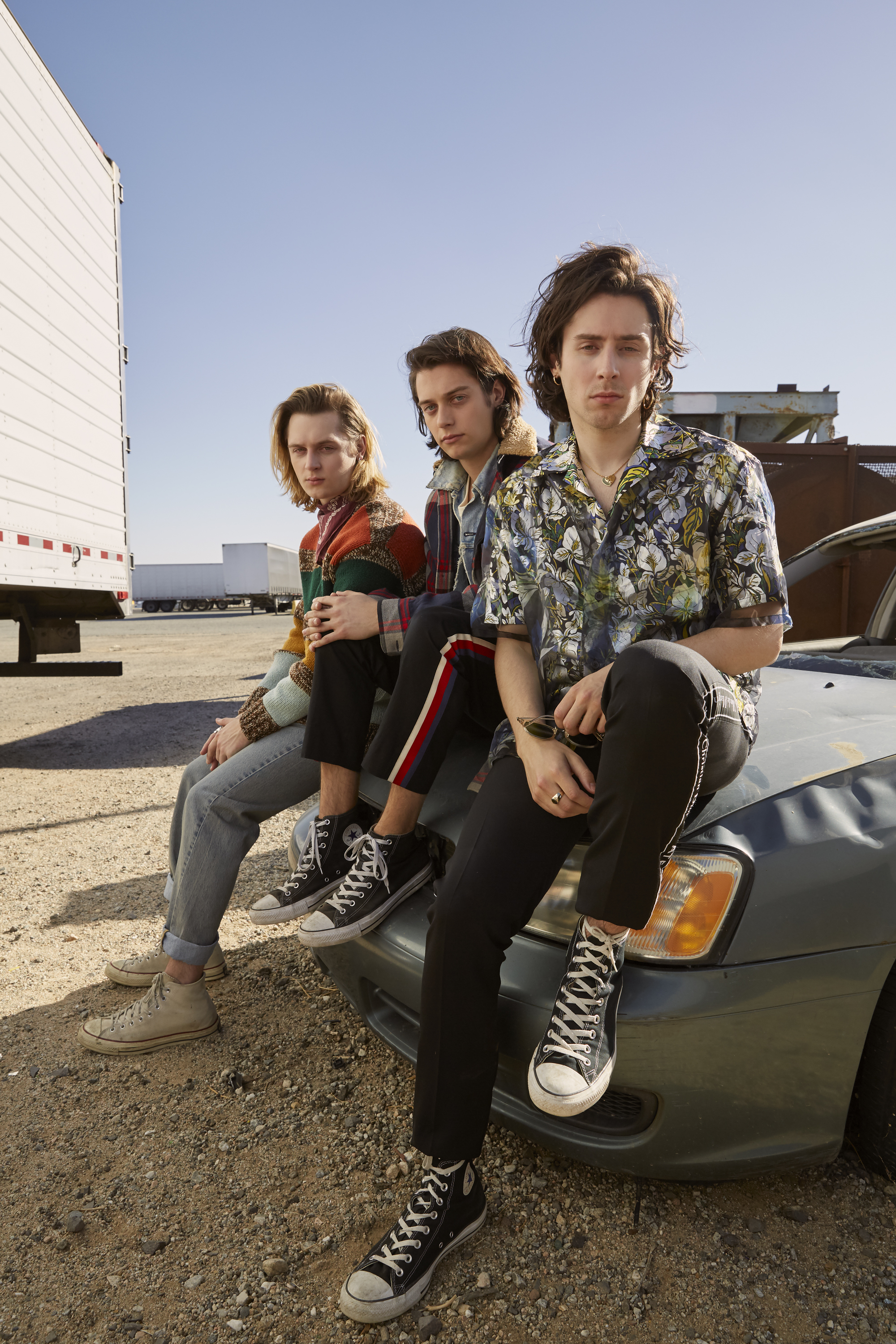 Left to right: GUCCI sweater and jeans, LEVI’S bandana, and CONVERSE shoes. NEW NOSTALGIA jacket, GUCCI shirt, t-shirt, and pants, and CONVERSE shoes. LOUIS VUITTON shirt, DIOR HOMME pants, and CONVERSE shoes.