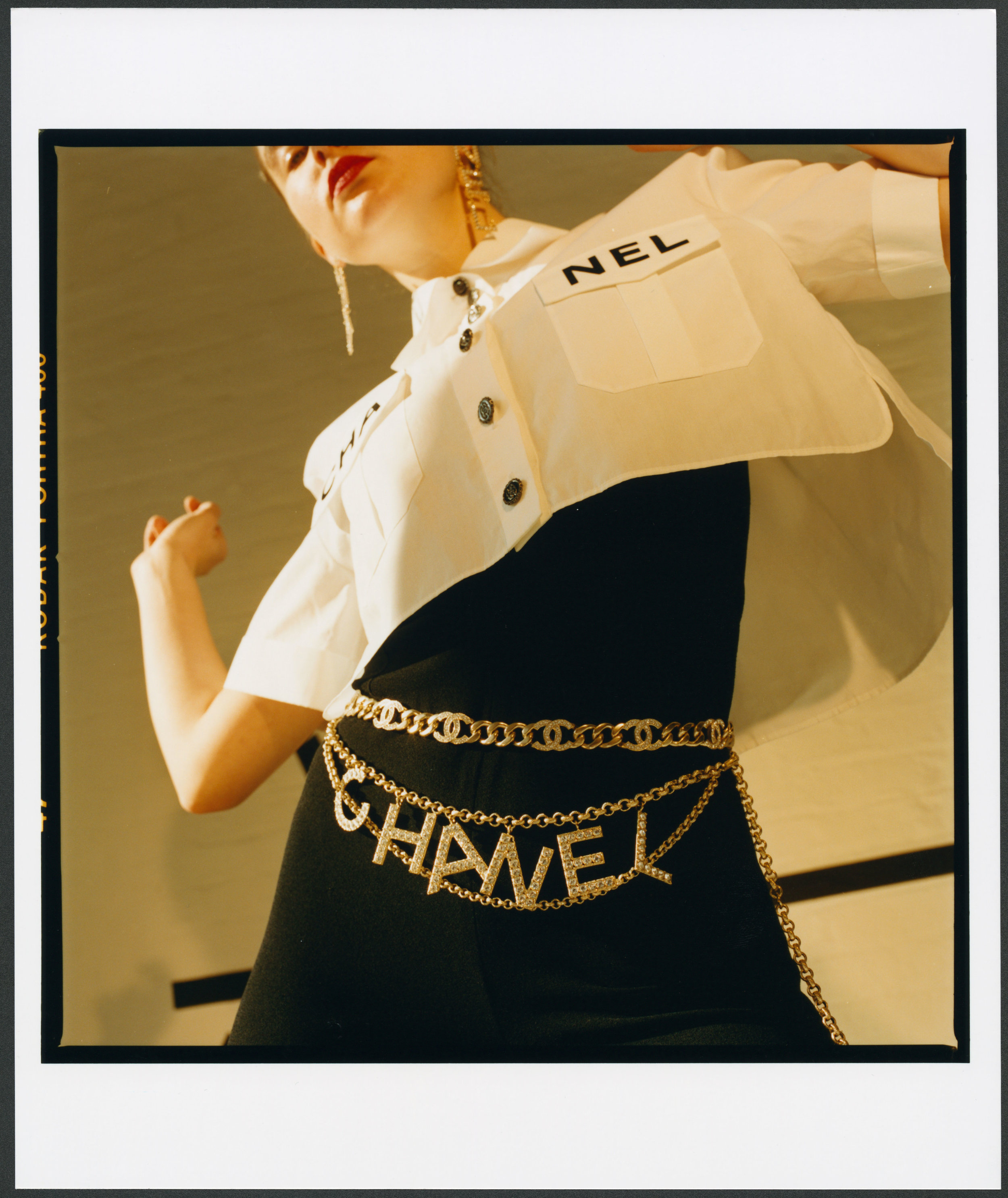 CHANEL shirt, pants, belt, and earrings.