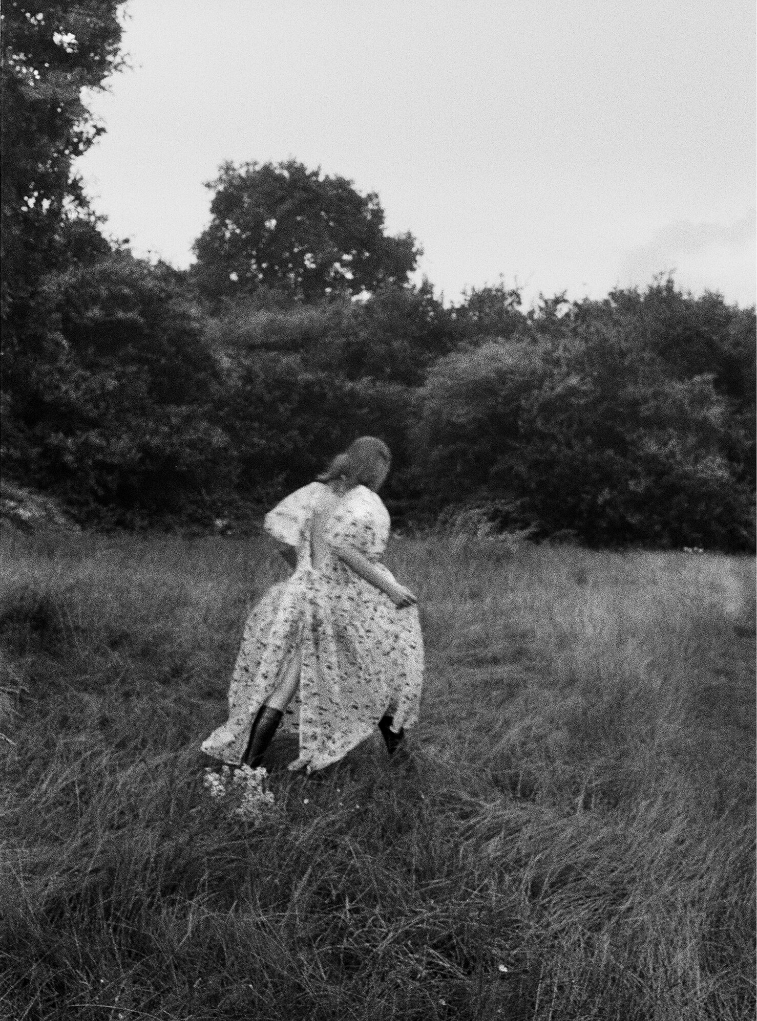 CECILIE BAHNSEN dress, SIMONE ROCHA hair clip, DIOR earrings, and ALEXANDER MCQUEEN boots.