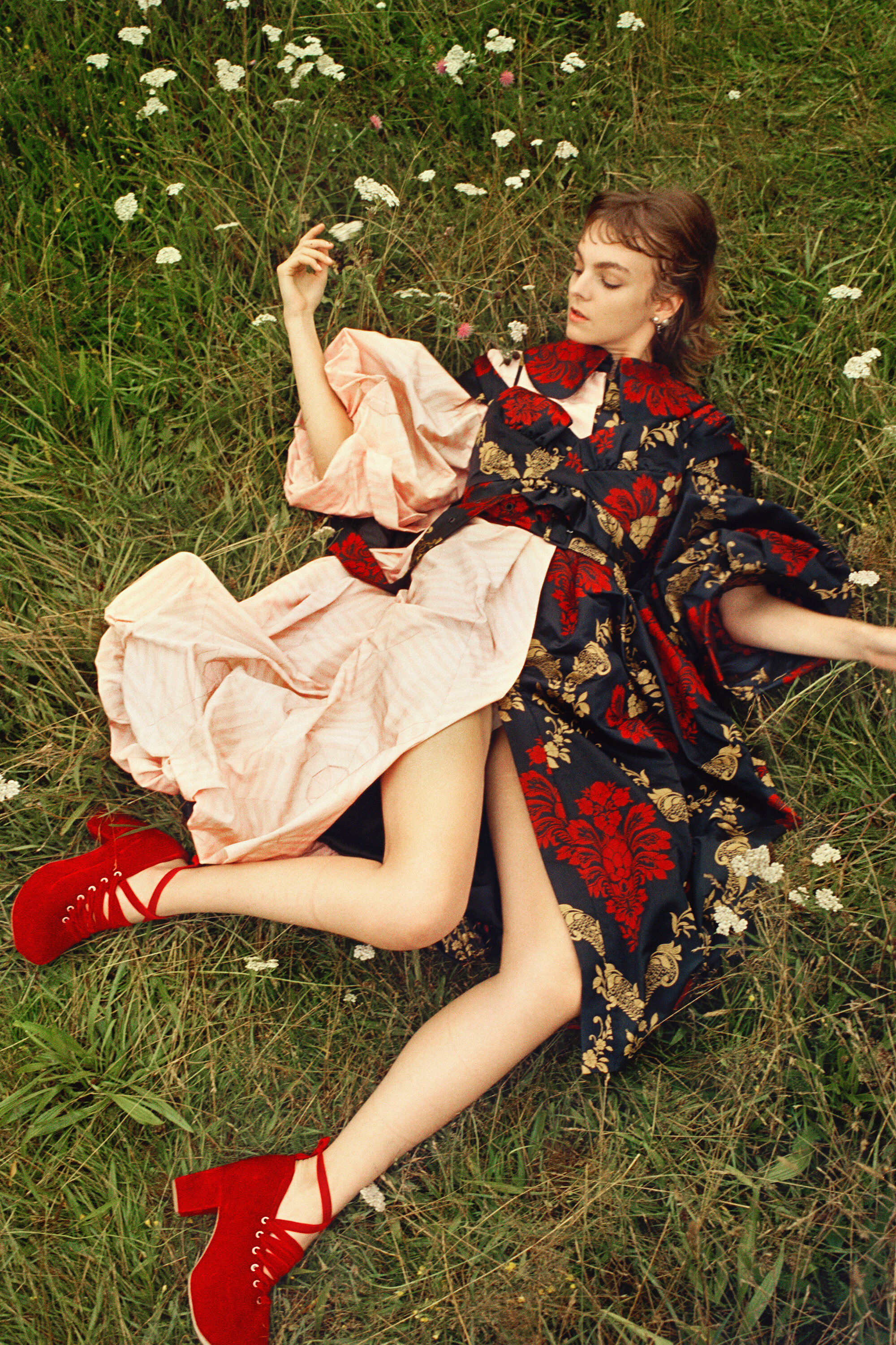 SIMONE ROCHA coat, bralette, and shoes and DIOR earrings.
