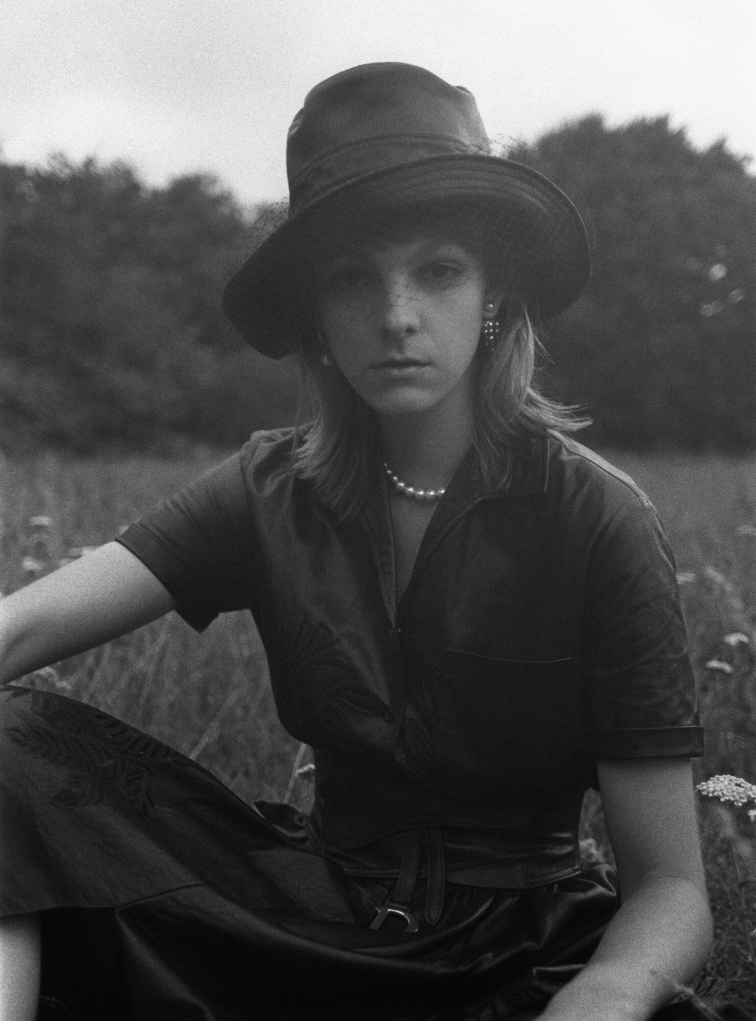 DIOR top, skirt, belt, necklace, earrings, and hat.