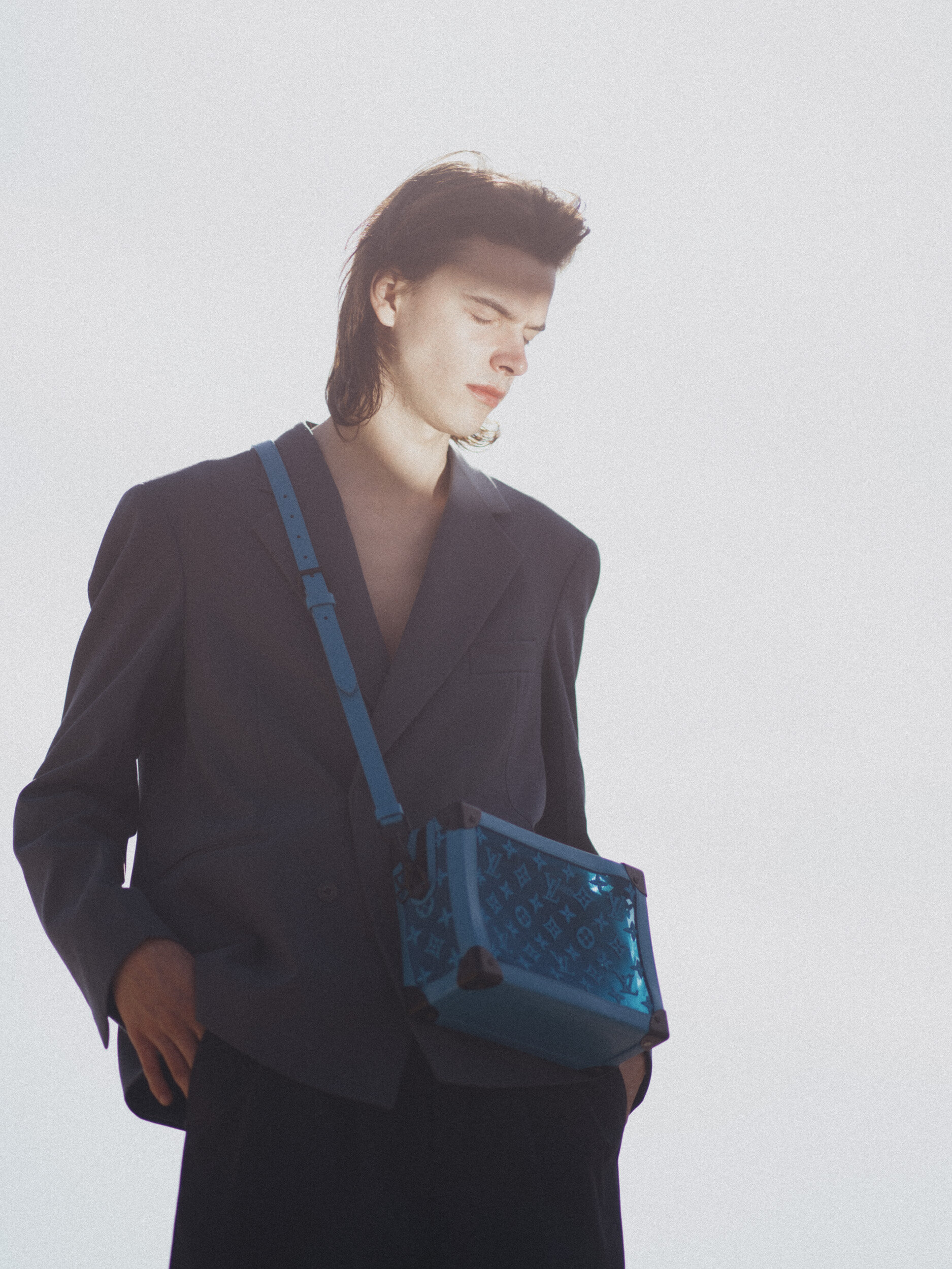 LOUIS VUITTON blazer, pants, and bag.
