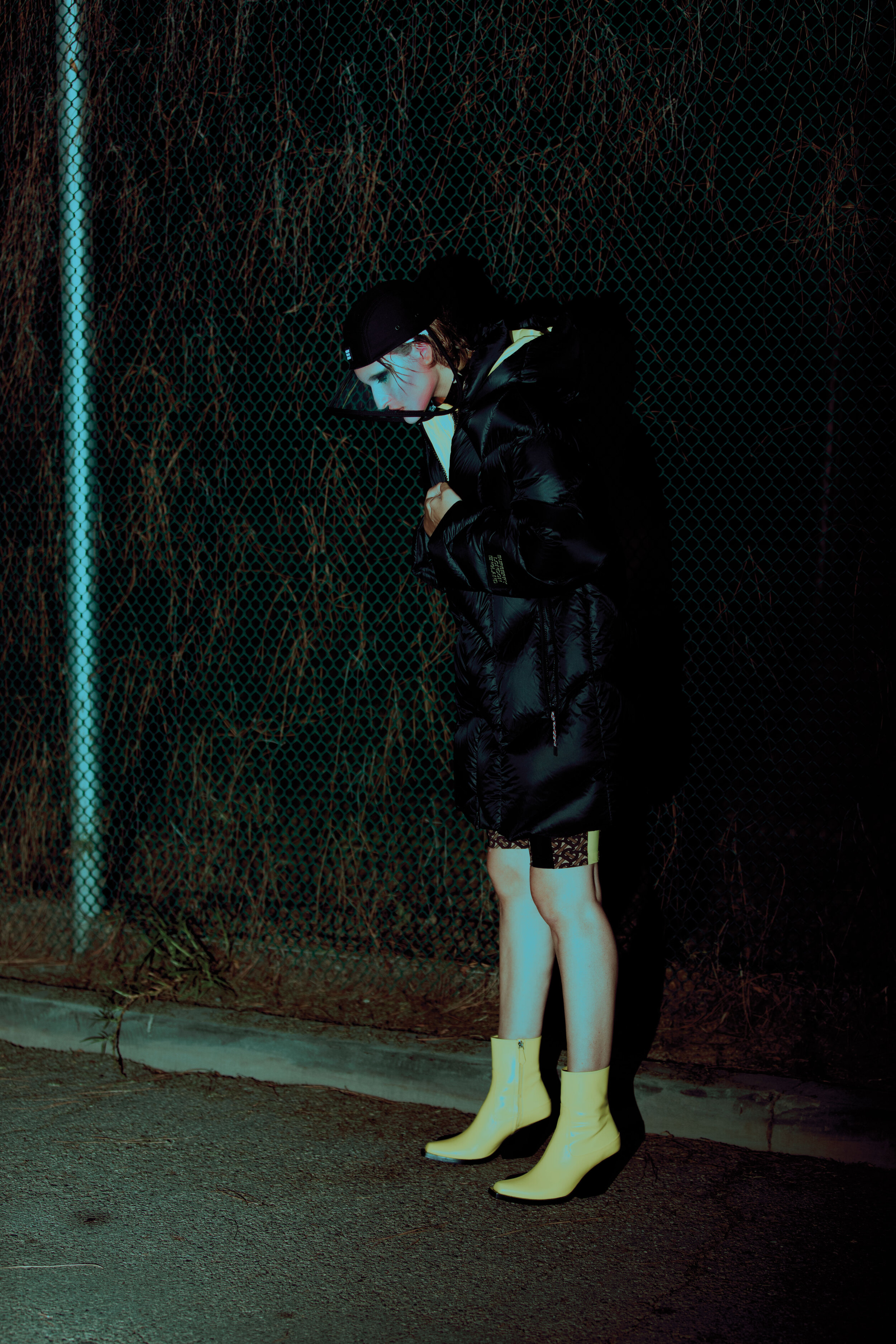 BURBERRY coat, bodysuit, boots, and hat and stylist’s own necklace.