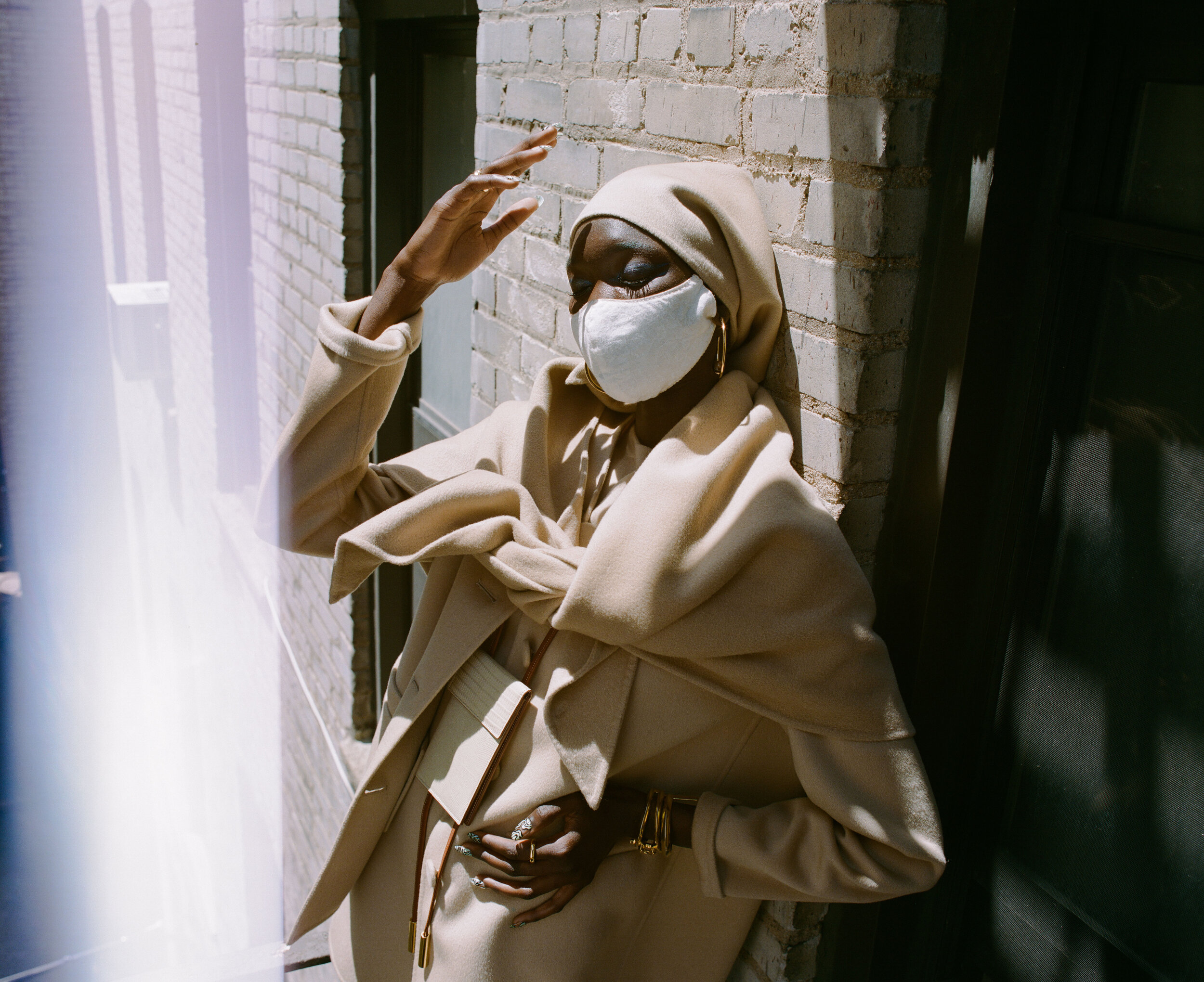 MARC JACOBS jacket, dress, shawl, leggings, shoes, and headscarf, ASHYA wallet bag, KHIRY earrings and ring, THIRD CROWN arm bracelets and ring and model’s own mask.
