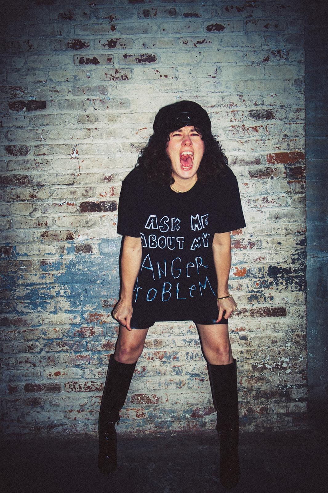 A person in a black shirt and boots screamingAI-generated content may be incorrect.