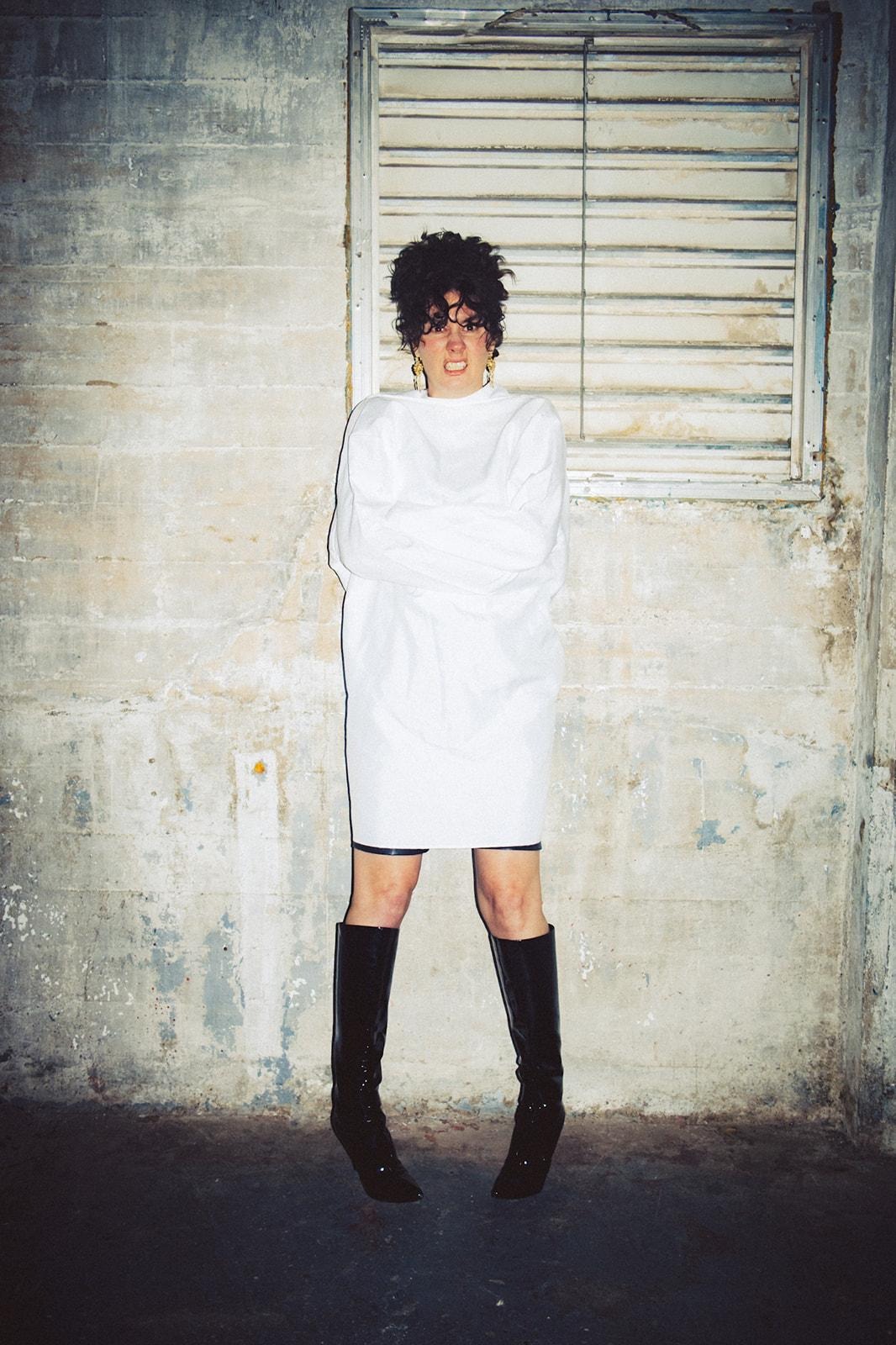 A person in a white dress and bootsAI-generated content may be incorrect.