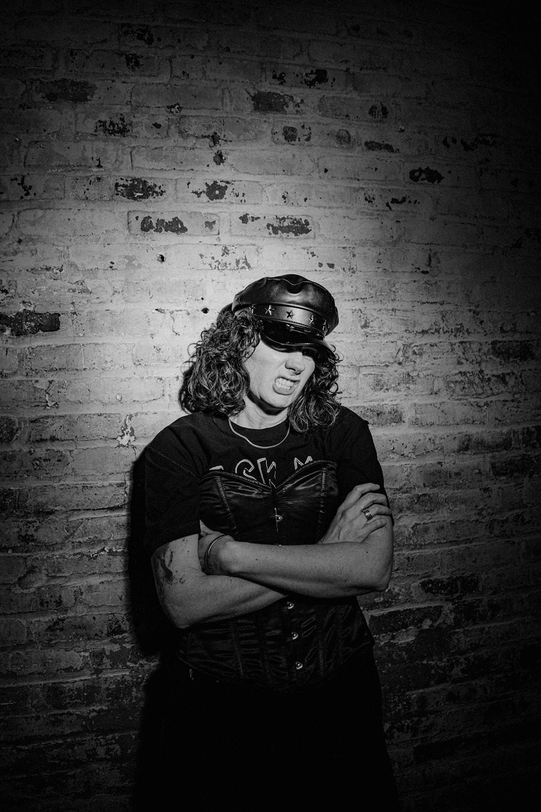 A person in a black shirt and hatAI-generated content may be incorrect.