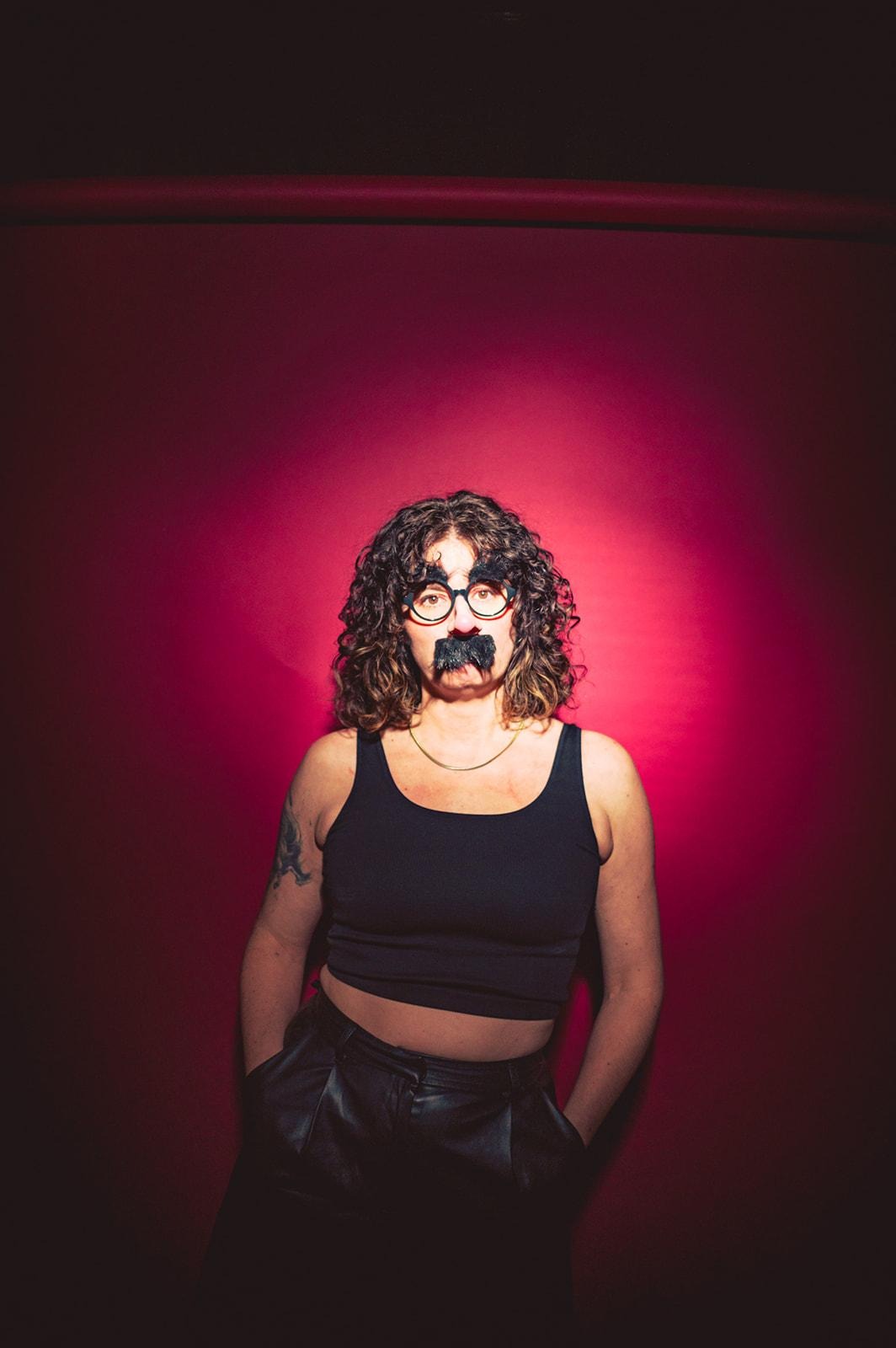 A person with a mustache and glassesAI-generated content may be incorrect.