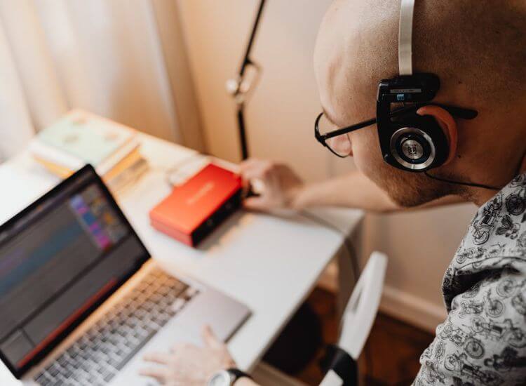 Beginner learning audio production using free online tutorials for home recording improvement.