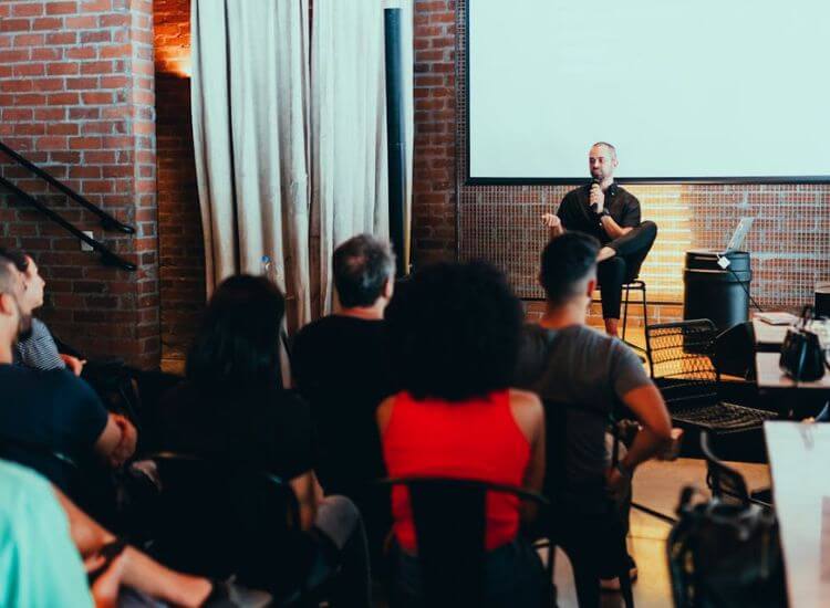 Team leader giving a motivational talk to colleagues during a meeting