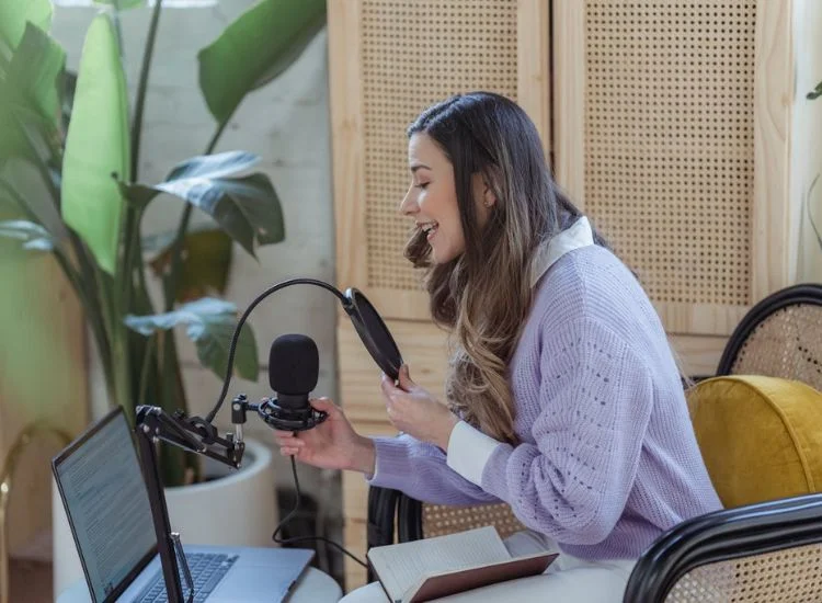 Podcaster recording a solo episode in a small studio