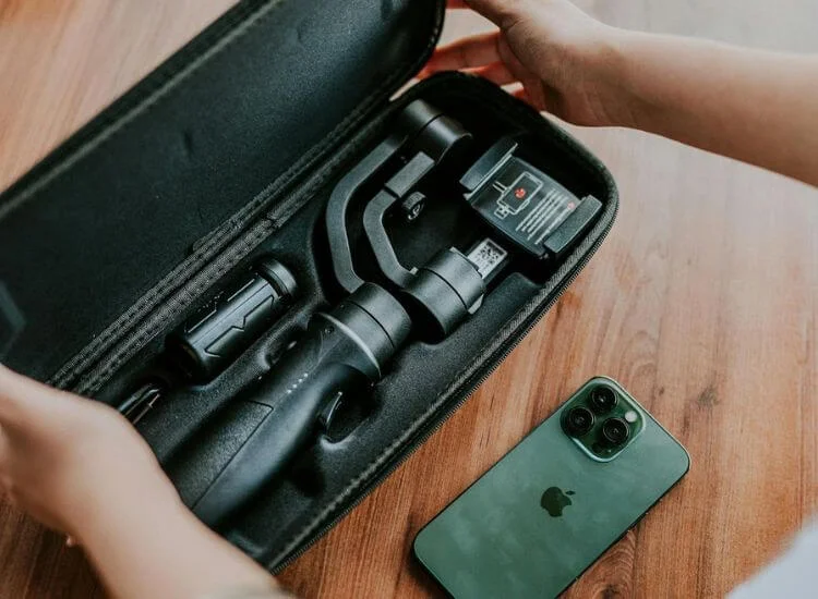 Essential travel vlogging gear, including a tripod and smartphone