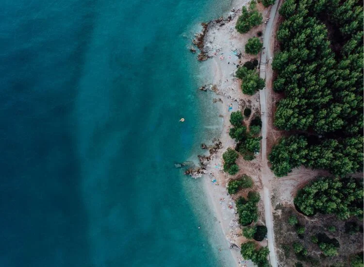 A drone capturing aerial footage of a beach, mountain, or scenic landscape.