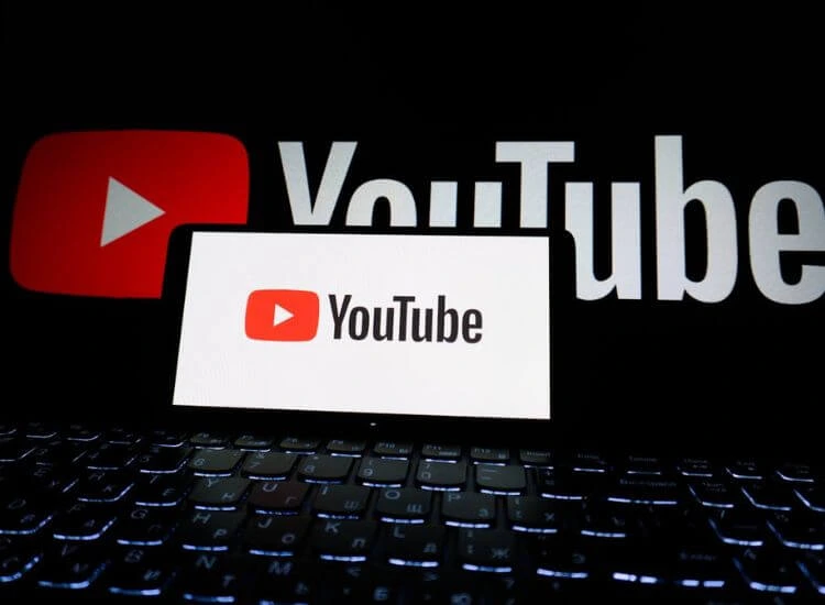YouTube logo showing on smartphone and laptop screens