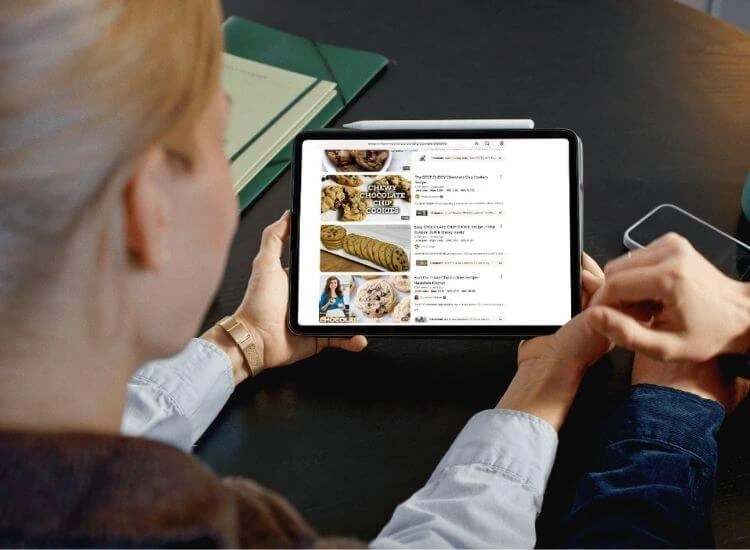 Viewers looking on YouTube thumbnails with titles on a tablet device