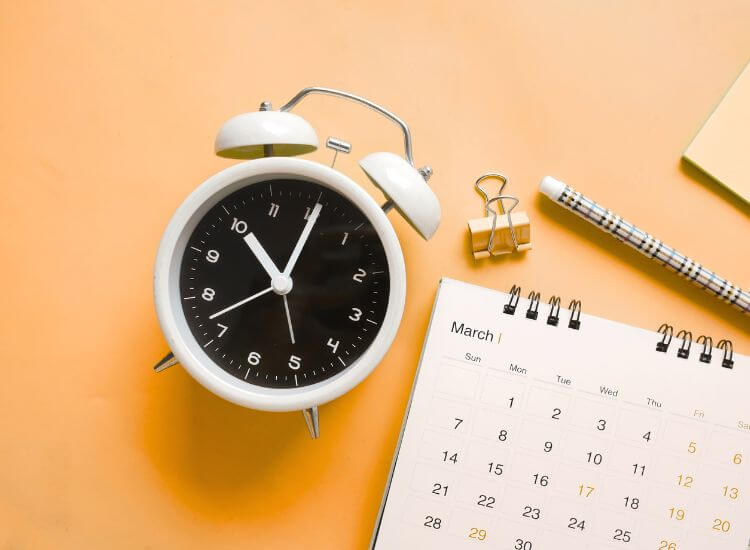 desk calendar and clock on a desk used for content scheduling