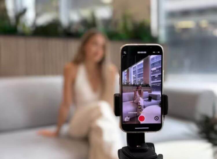 content creator using smartphone for filming content