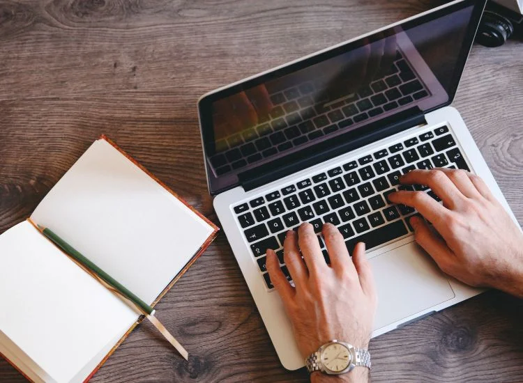 writing a YouTube script on a laptop