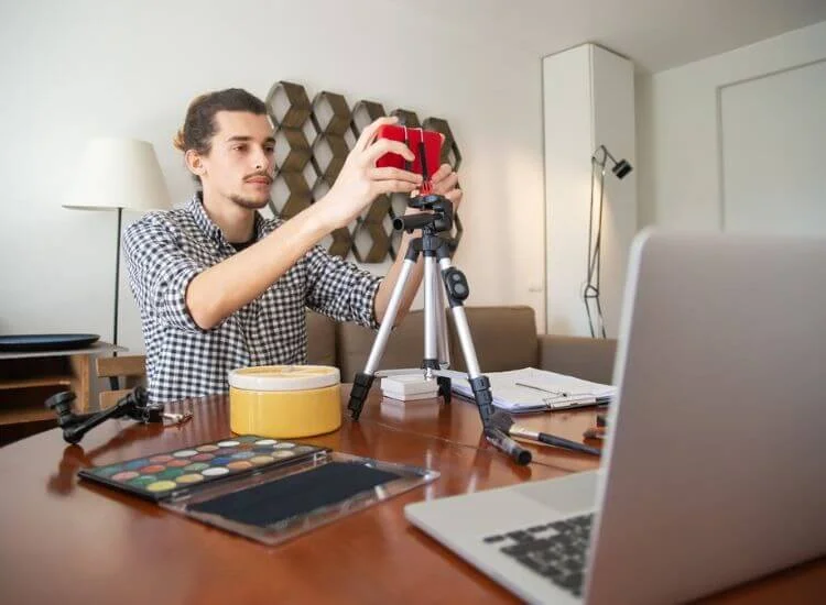 a vlogger fixing smartphone before filming