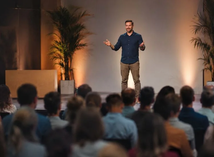Relaxed, confident speaker engaging an audience