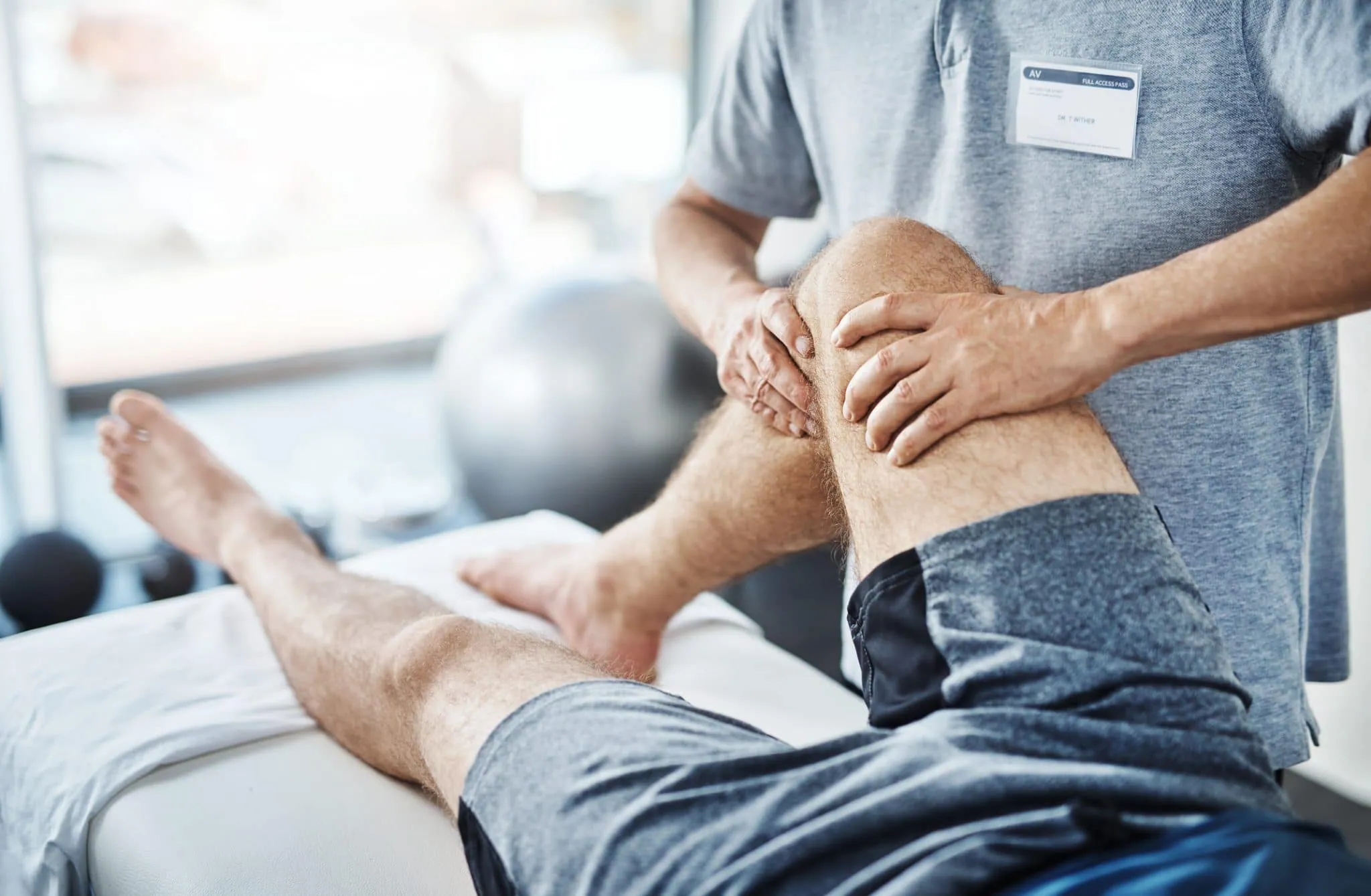Massage therapist treating a client's knee