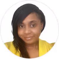Portrait of a woman with long black hair wearing a yellow top, smiling gently against a white background.