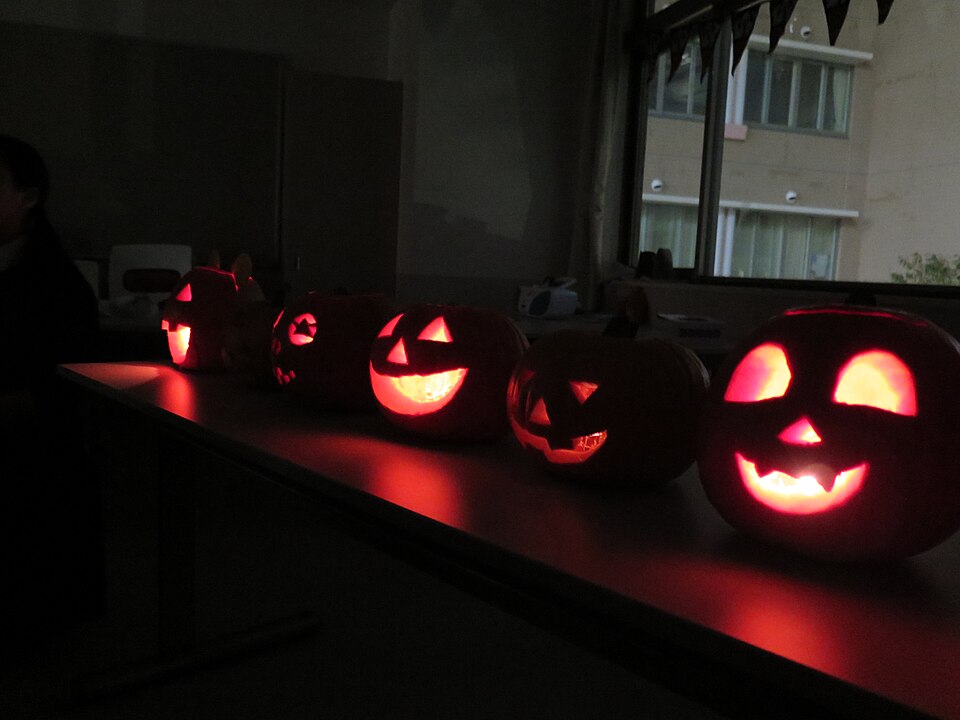 Halloween illustration: five glowing jack-o’-lanterns on a table, 2014 file photograph