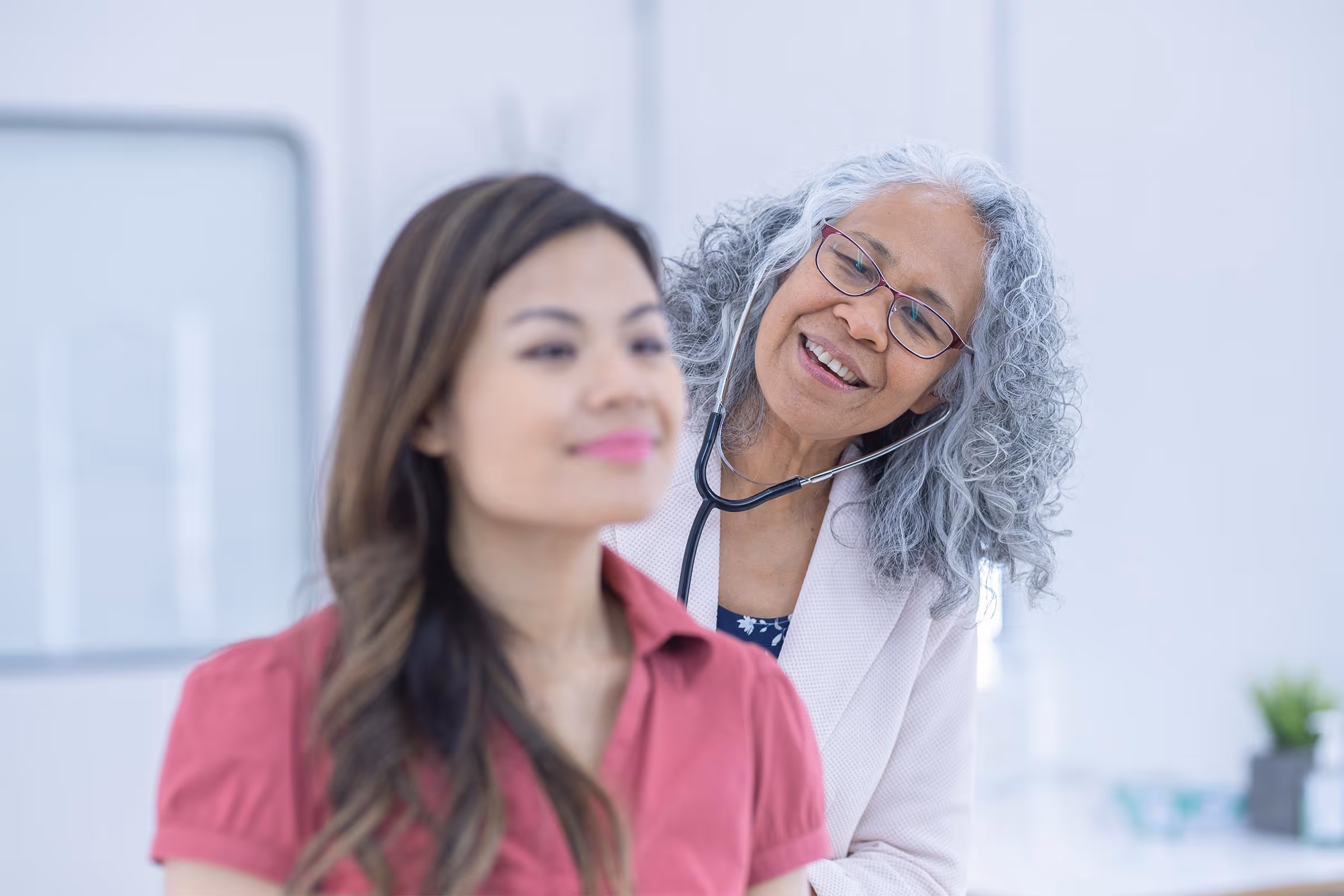 A doctor listening through a stethoscope.