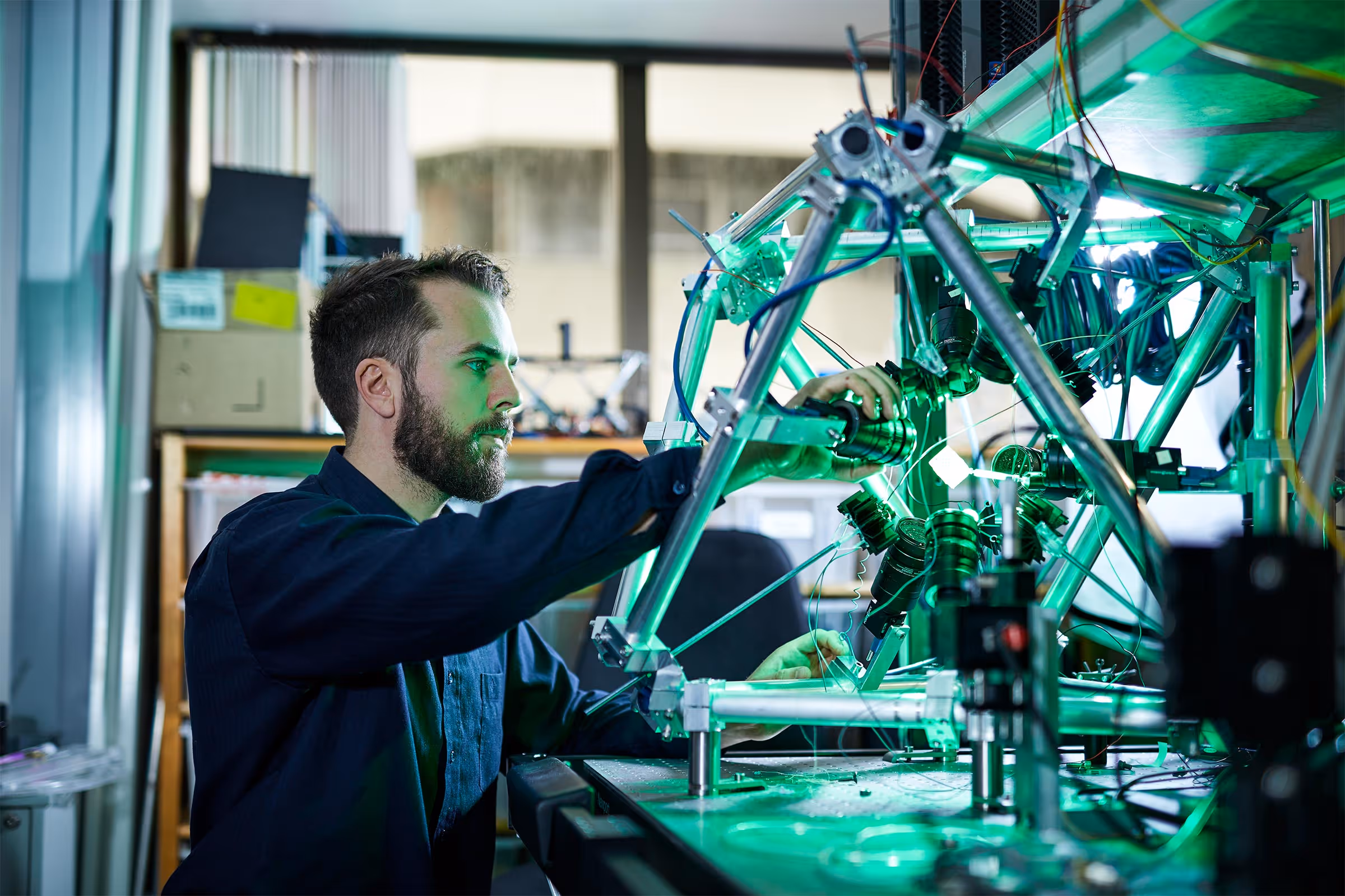 A scientist running an experiment with a laser.