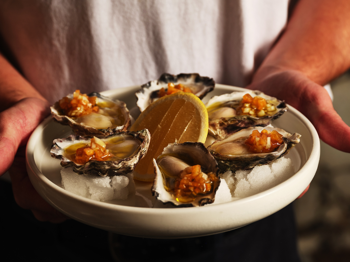 chef and waiter with green product