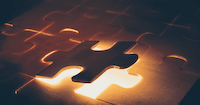 Investment Manger Selector looking for the best asset manager depicted by the fitting piece of a jigsaw puzzle.