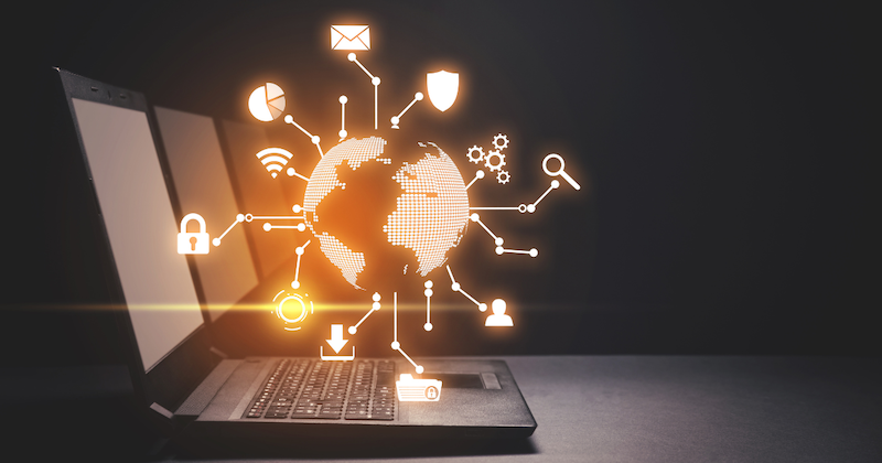 Laptop with a glowing digital globe and various technology icons symbolising a global digital infrastructure.