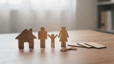 small icon house and family on a table with a key.