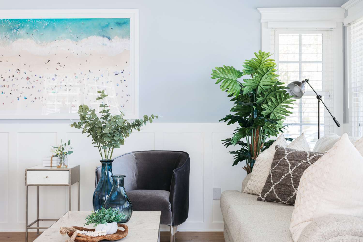 Soft blue walls with beige furniture.