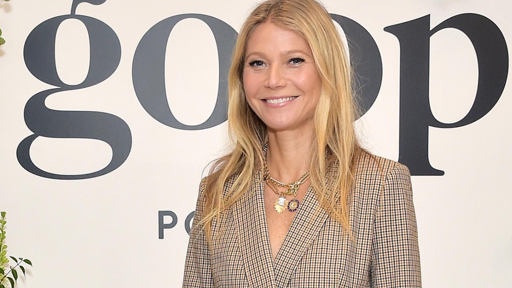 Gwyneth Paltrow in front of a goop sign.