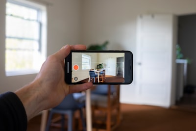 Hand taking a video of a property during a tour.