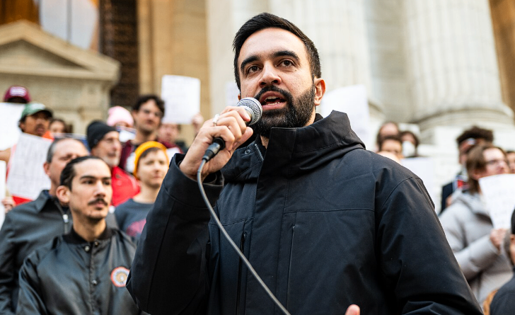 Zohran Mamdani talking into a microphone.