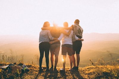 Family hugging on mountain.