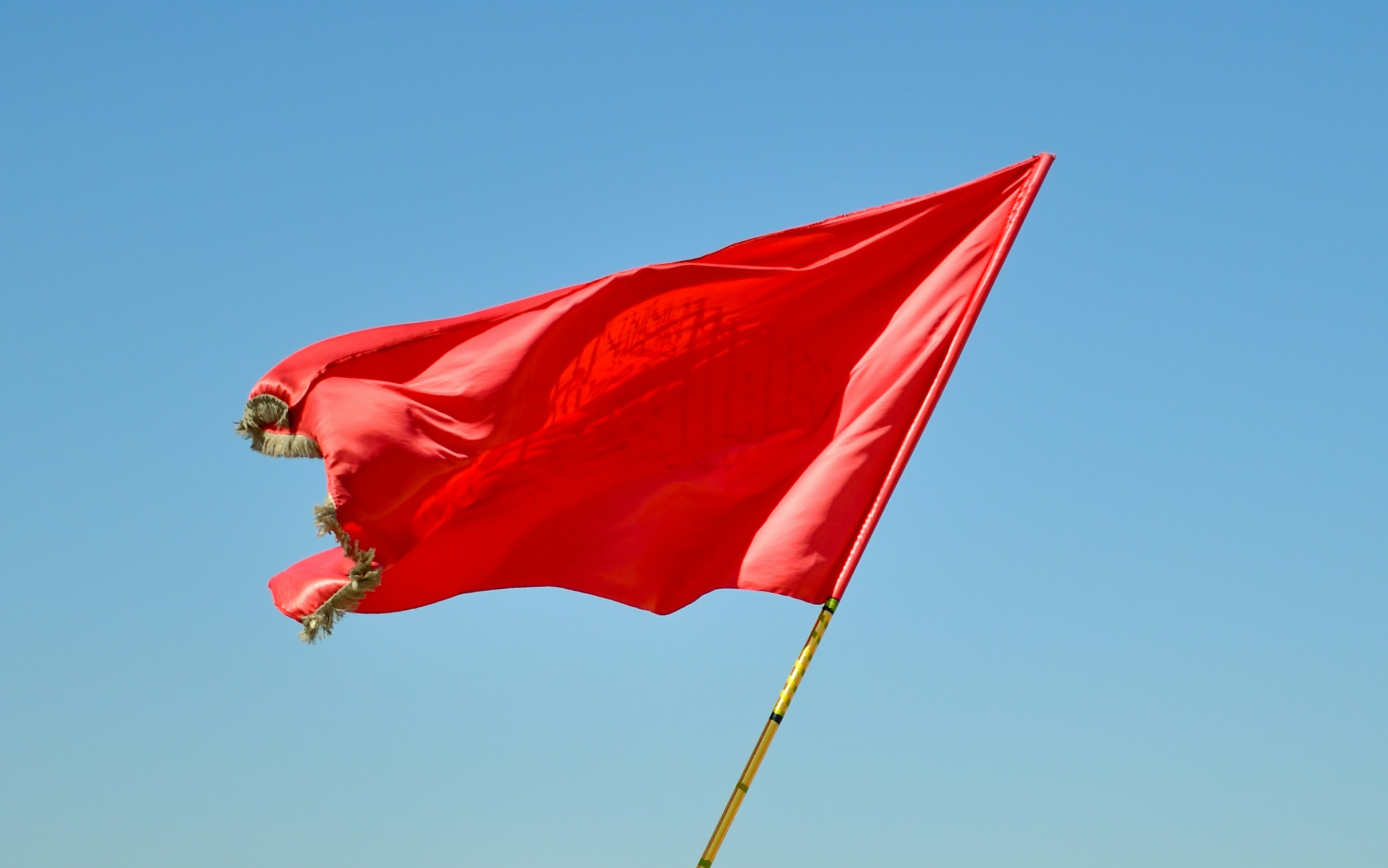 Red flag waving in air. 